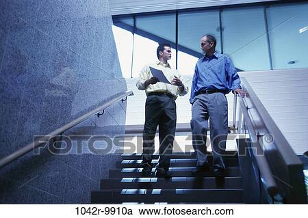 Stock Image - men, stairs, business, Middle-aged, businessmen, indoors, Caucasian. Fotosearch