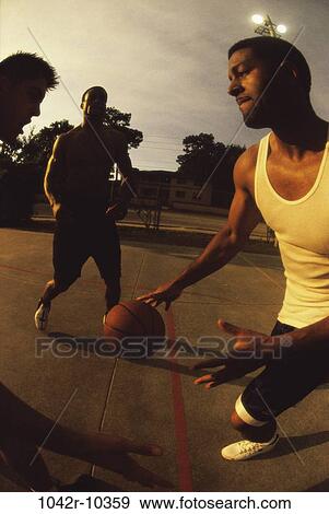 Stock Photo - multiethnic, men, people, playing, evening, sports, basketball. Fotosearch