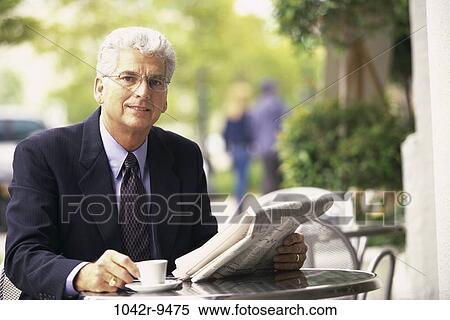 Stock Photography - newspaper, senior, reading, drinking, business, outdoors. Fotosearch