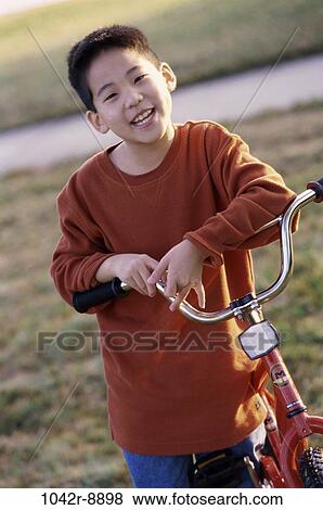 Stock Photo - people, Asian, bicycle, riding, boy, outdoors, bike. Fotosearch