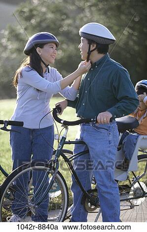 Stock Image - people, Asian, bicycles, family, seat, helping. Fotosearch