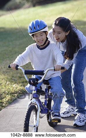 Stock Photo - people, Asian, mother, bicycle, helmet, riding, outdoors. Fotosearch