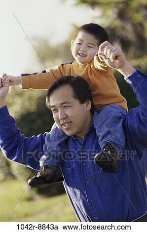 Stock Image - people, Asian, outdoors, carrying, family, father. Fotosearch