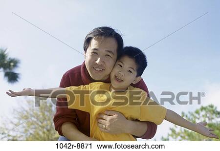 Stock Image - people, Asian, outdoors, hugging, family, affection. Fotosearch