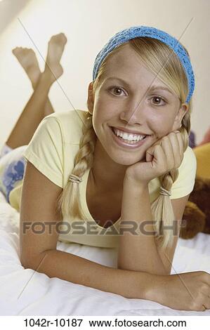 Stock Photo - people, blond, laying, indoors, teenager, Caucasian. Fotosearch