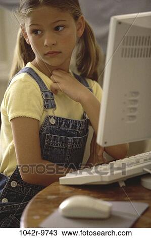 Stock Image - people, computer, girl, child, using, distracted, indoors. Fotosearch