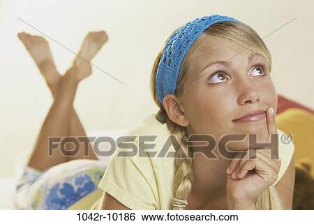 Stock Photograph - people, contemplation, blond, contemplating, thinking, laying, think. Fotosearch