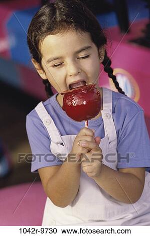 Stock Image - people, eating, apple, girl, child, brunette, indoors. Fotosearch
