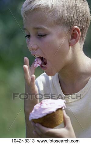 Stock Image - people, eating, boy, outdoors, child, blond, dessert. Fotosearch