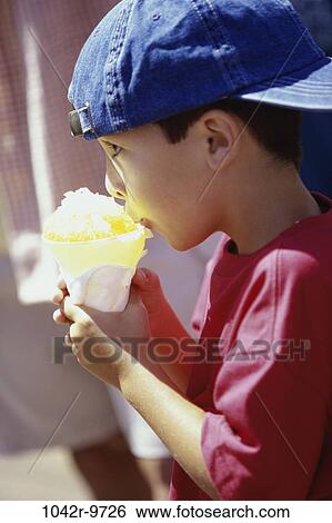 Stock Photograph - people, eating, hat, ice, boy, outdoors, child. Fotosearch