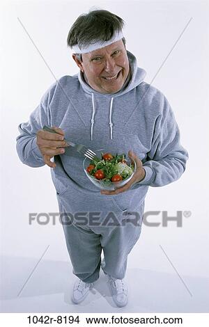 people, eating, smiling, sweatshirt, healthy, fork View Large Photo Image Picture - people, eating, smiling, sweatshirt, healthy, fork. Fotosearch