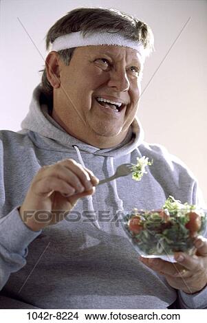 Picture - people, eating, sweatshirt, healthy, fork, salad. Fotosearch