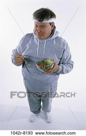 Stock Image - people, eating, sweatshirt, healthy, salad, diet. Fotosearch