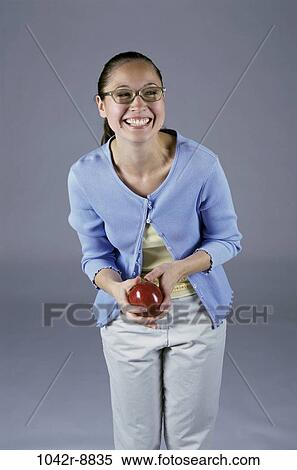Stock Photography - people, eating, woman, eyeglasses, healthy, apple, fruit. Fotosearch