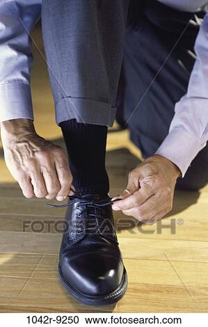 people, hands, tie, shoe, lace, kneeling View Large Photo Image Stock Image - people, hands, tie, shoe, lace, kneeling. Fotosearch