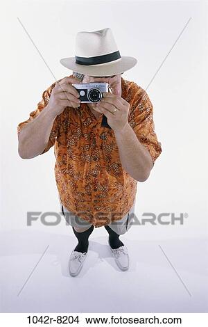 Picture - people, hat, Middle-aged, vacations, camera, humor. Fotosearch