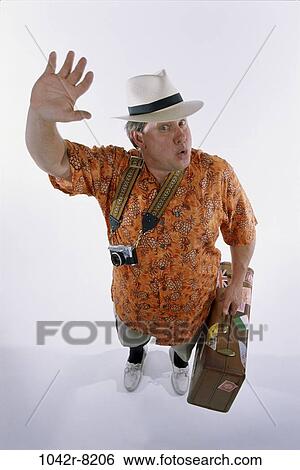 Stock Photograph - people, hat, Middle-aged, vacations, camera, waving. Fotosearch