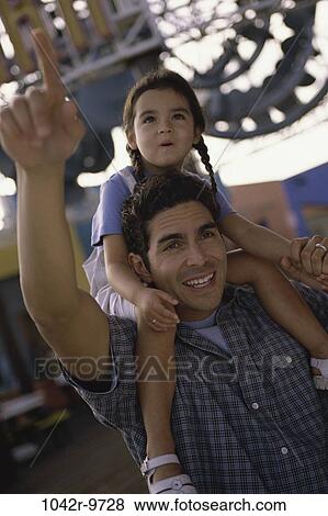 people, Hispanic, riding, pointing, outdoors, park, amusement View Large Photo Image Stock Photo - people, Hispanic, riding, pointing, outdoors, park, amusement. Fotosearch