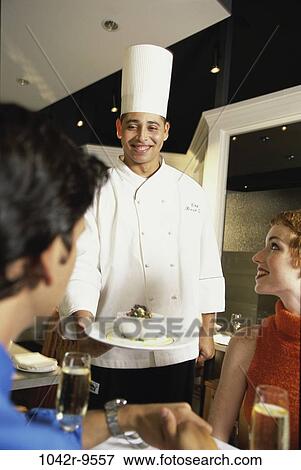 Stock Photo - people, industry, couple, presentation, occupations, hospitality, dining out. Fotosearch