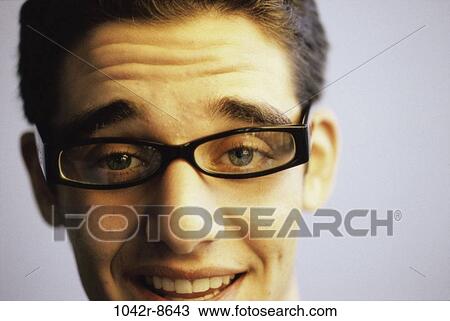 Stock Image - people, male, eyeglasses, brunette, indoors, teenager. Fotosearch