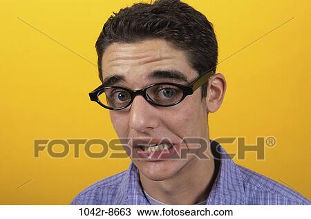 Stock Image - people, male, eyeglasses, brunette, worry, indoors. Fotosearch