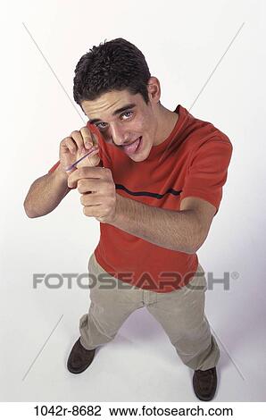 Stock Image - people, male, mischievous, brunette, aim, indoors. Fotosearch