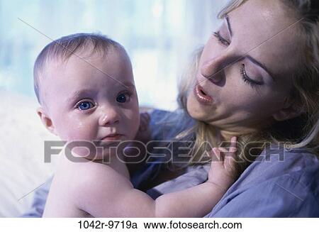 Stock Image - people, mother, crying, holding, frustrated, family, comforting. Fotosearch