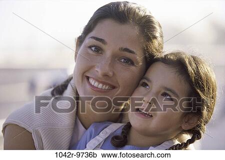 Stock Image - people, mother, Hispanic, outdoors, hugging, family, hug. Fotosearch