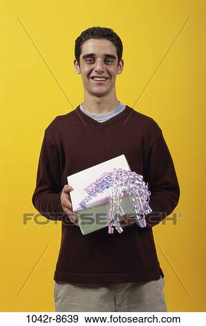 people, party, male, birthday, holding, gift, present View Large Photo Image Stock Photo - people, party, male, birthday, holding, gift, present. Fotosearch
