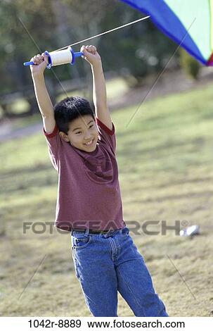 Stock Photo - people, playing, Asian, flying, boy, outdoors, child. Fotosearch