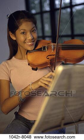 Stock Photo - people, playing, Hispanic, violin, play, indoors. Fotosearch