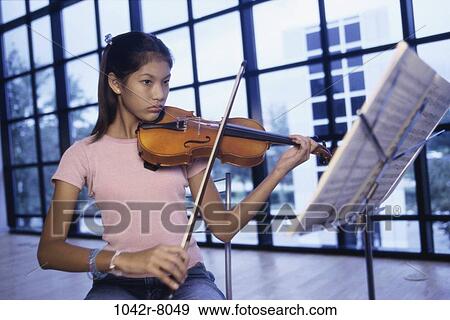 Stock Photo - people, playing, Hispanic, violin, serious, play. Fotosearch