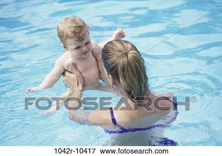 Stock Photo - people, pool, mother, baby, outdoors, family. Fotosearch