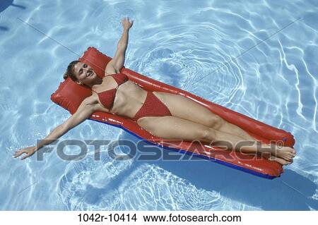 people, pool, woman, outdoors, sunbathing, float View Large Photo Image Picture - people, pool, woman, outdoors, sunbathing, float. Fotosearch