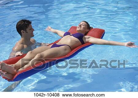 people, swim, relaxation, floating, pool, couple View Large Photo Image Stock Photo - people, swim, relaxation, floating, pool, couple. Fotosearch