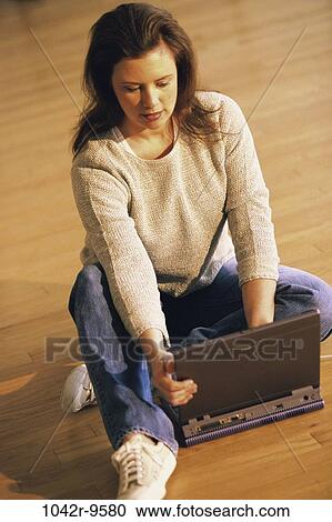 Stock Image - people, woman, computer, laptop, concentrating, Middle-aged, using. Fotosearch