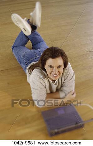 people, woman, computer, laptop, sweater, Middle-aged, laying View Large Photo Image Stock Image - people, woman, computer, laptop, sweater, Middle-aged, laying. Fotosearch