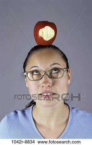 Picture - people, woman, eyeglasses, Hispanic, apple, fruit, brunette. Fotosearch