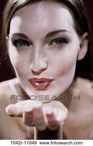 Stock Photo - people, woman, flirting, lips, blowing, brunette, flirtatious. Fotosearch