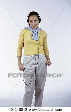 Stock Image - people, woman, headset, Asian, listening, music, indoors. Fotosearch