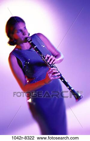 Stock Image - people, woman, playing, arts, entertainment, play, brunette. Fotosearch