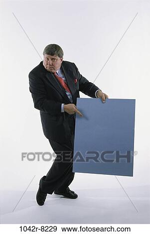 Stock Photo - presentation, pointing, business, point, Middle-aged, sign. Fotosearch