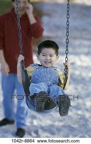 sand, people, Asian, swinging, swing, playground, outdoors View Large Photo Image Picture - sand, people, Asian, swinging, swing, playground, outdoors. Fotosearch