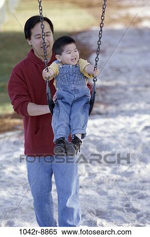 sand, people, Asian, swinging, swing, playground, outdoors View Large Photo Image Stock Photography - sand, people, Asian, swinging, swing, playground, outdoors. Fotosearch