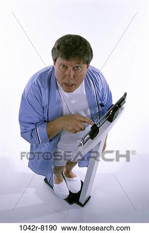 Stock Image - scales, people, morning, diet, slippers, Middle-aged. Fotosearch