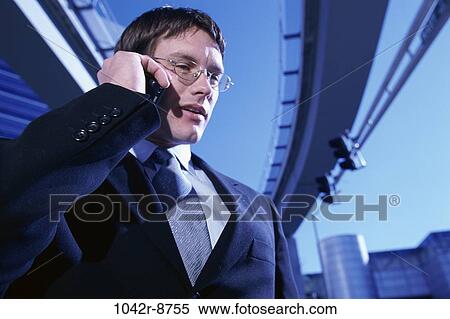 Stock Photography - talking, eyeglasses, phone, business, outdoors, Middle-aged. Fotosearch