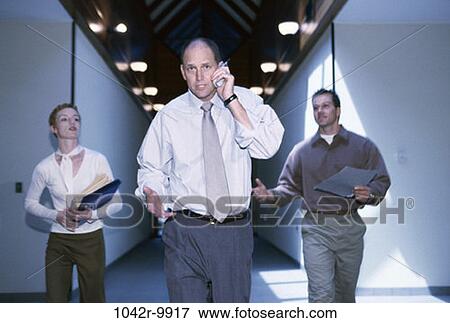 Stock Photo - talking, phone, hallway, business, Middle-aged, administrative, cell phone. Fotosearch
