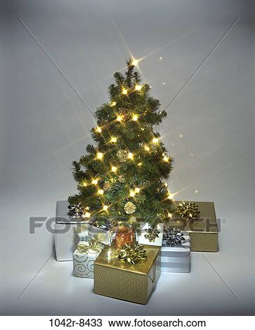 Stock Image - tree, Christmas, Christmas tree, gifts, presents, lights, still life. Fotosearch