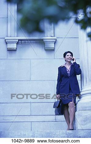 Stock Photo - tree, woman, building, talking, window, Hispanic, column. Fotosearch