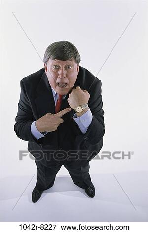 Stock Photo - watch, pointing, business, point, Middle-aged, humor. Fotosearch
